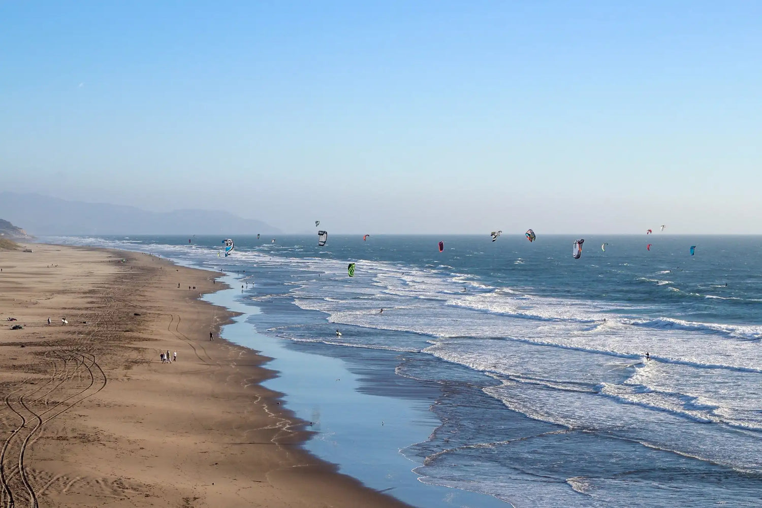 Beach sand with footprints and ocean waves