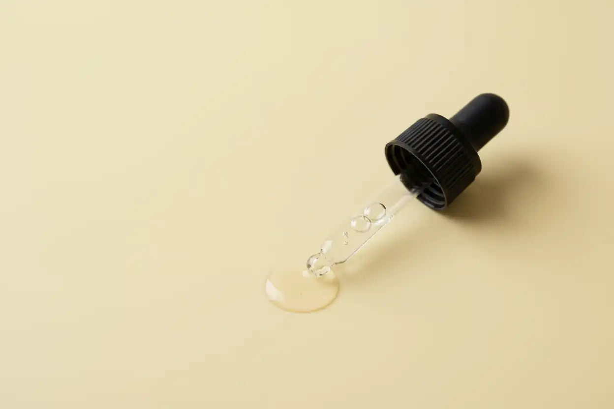 MAKE MEDICINE DROPPER SMALL AND PLACE ON A PALE YELLOW BACKGROUND
